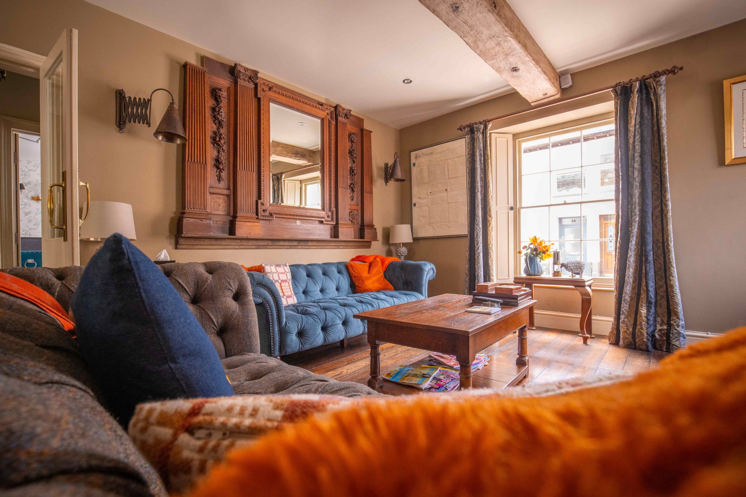 a bright living room space with big sofas, throws and good sized cushions.