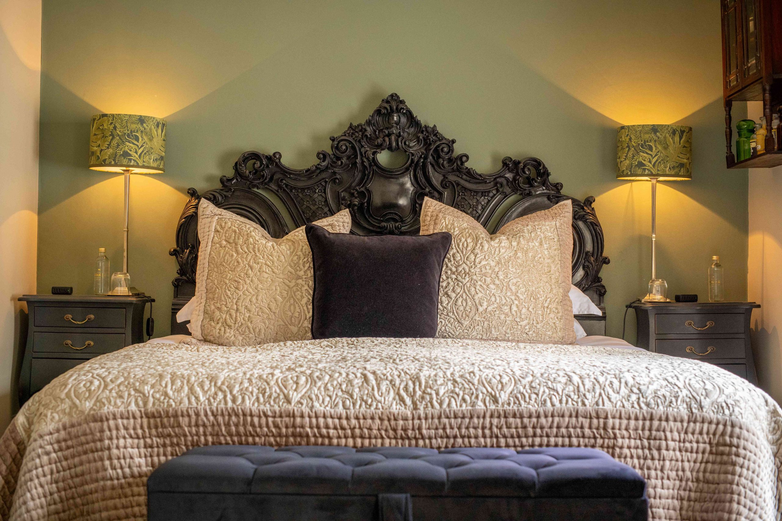 A Double room with an antique wooden headboard, good lighting and very comfy bead