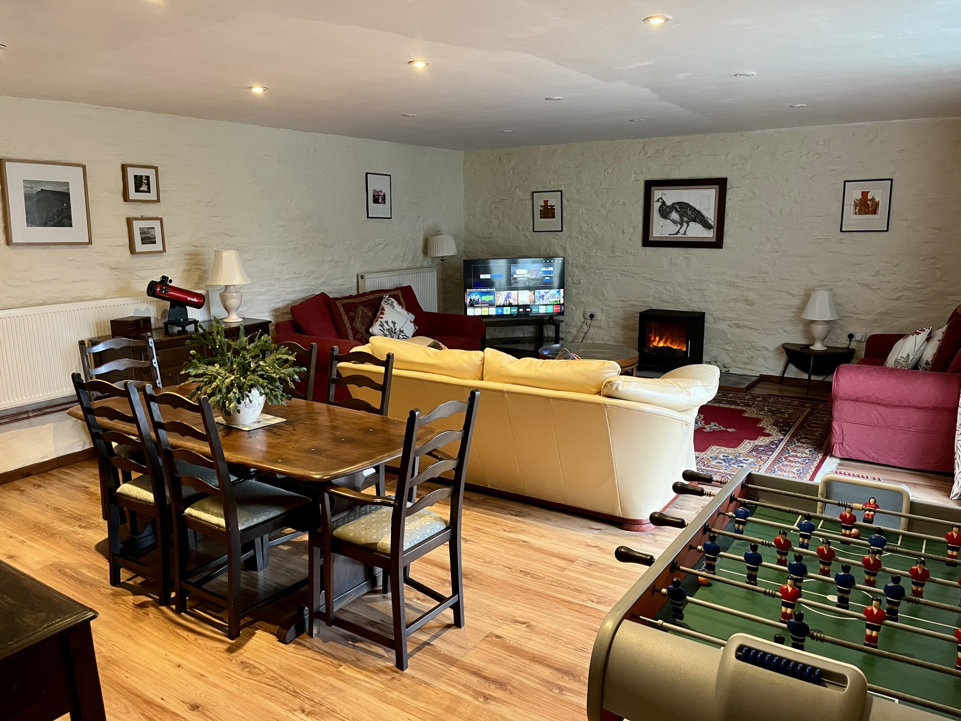 a comfy living space with sofas and a dining table in the one room