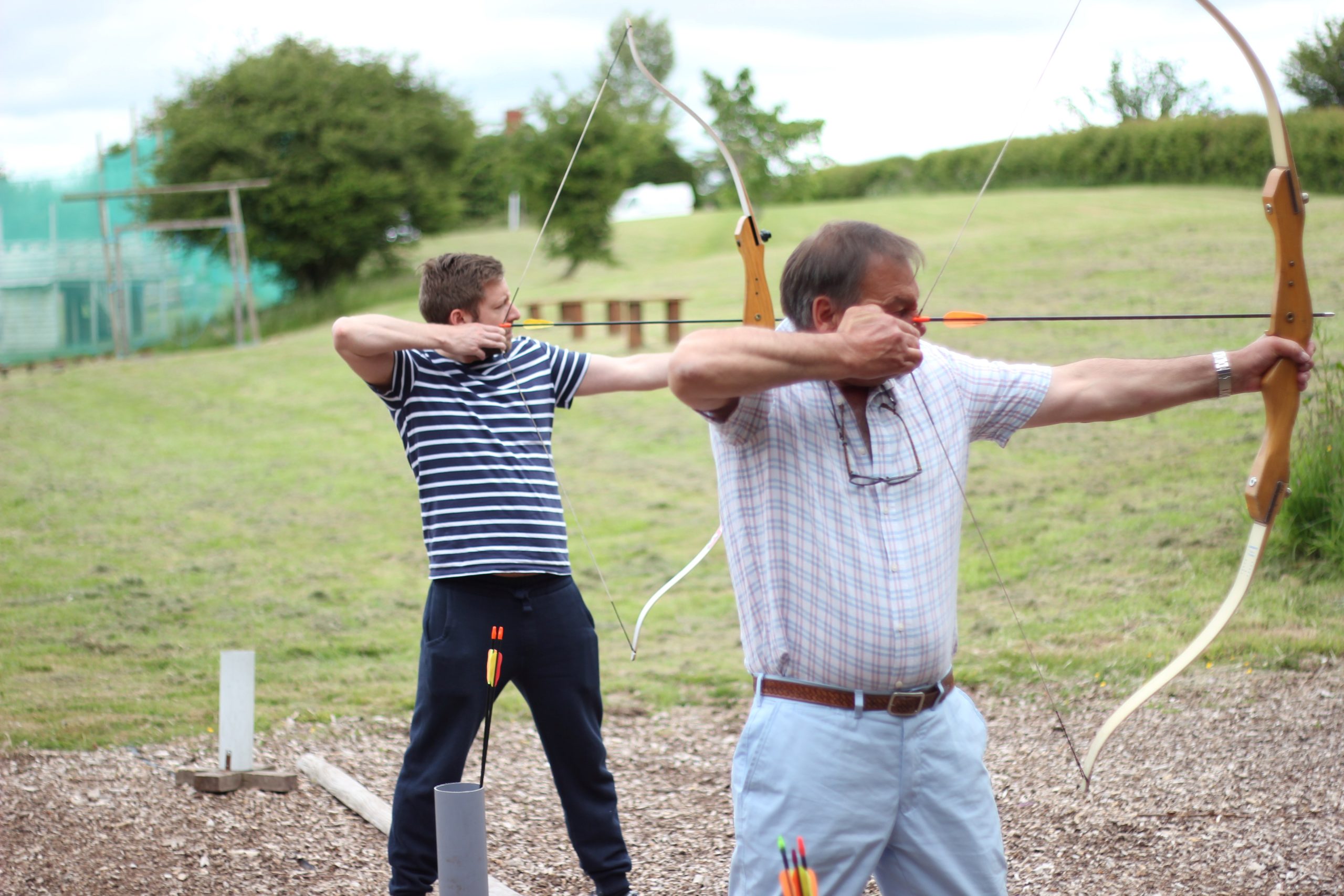 a group doing archery at the centre under instruction