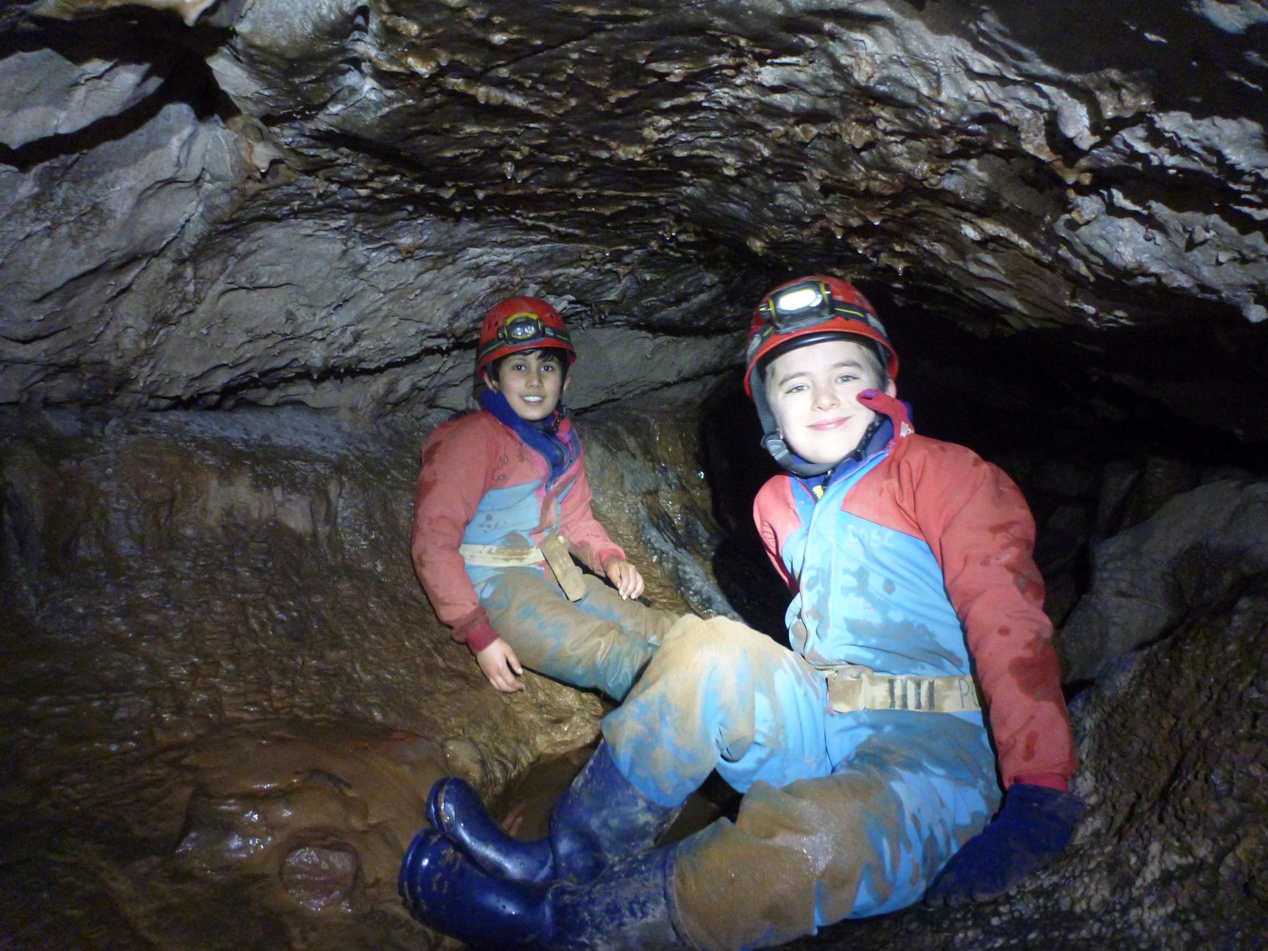 2 young people underground in a caving adventure