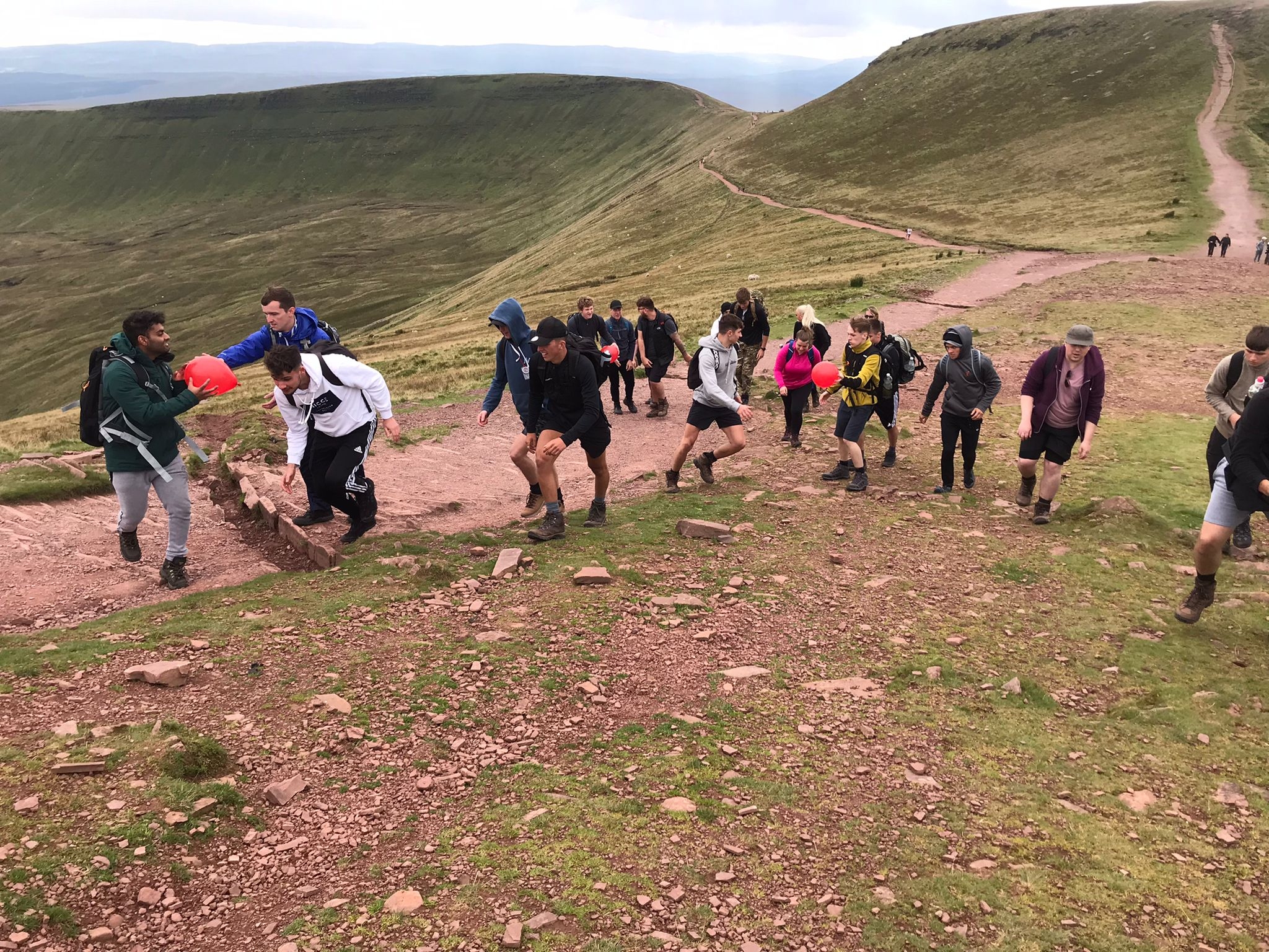 A group of young people descending Corn Du