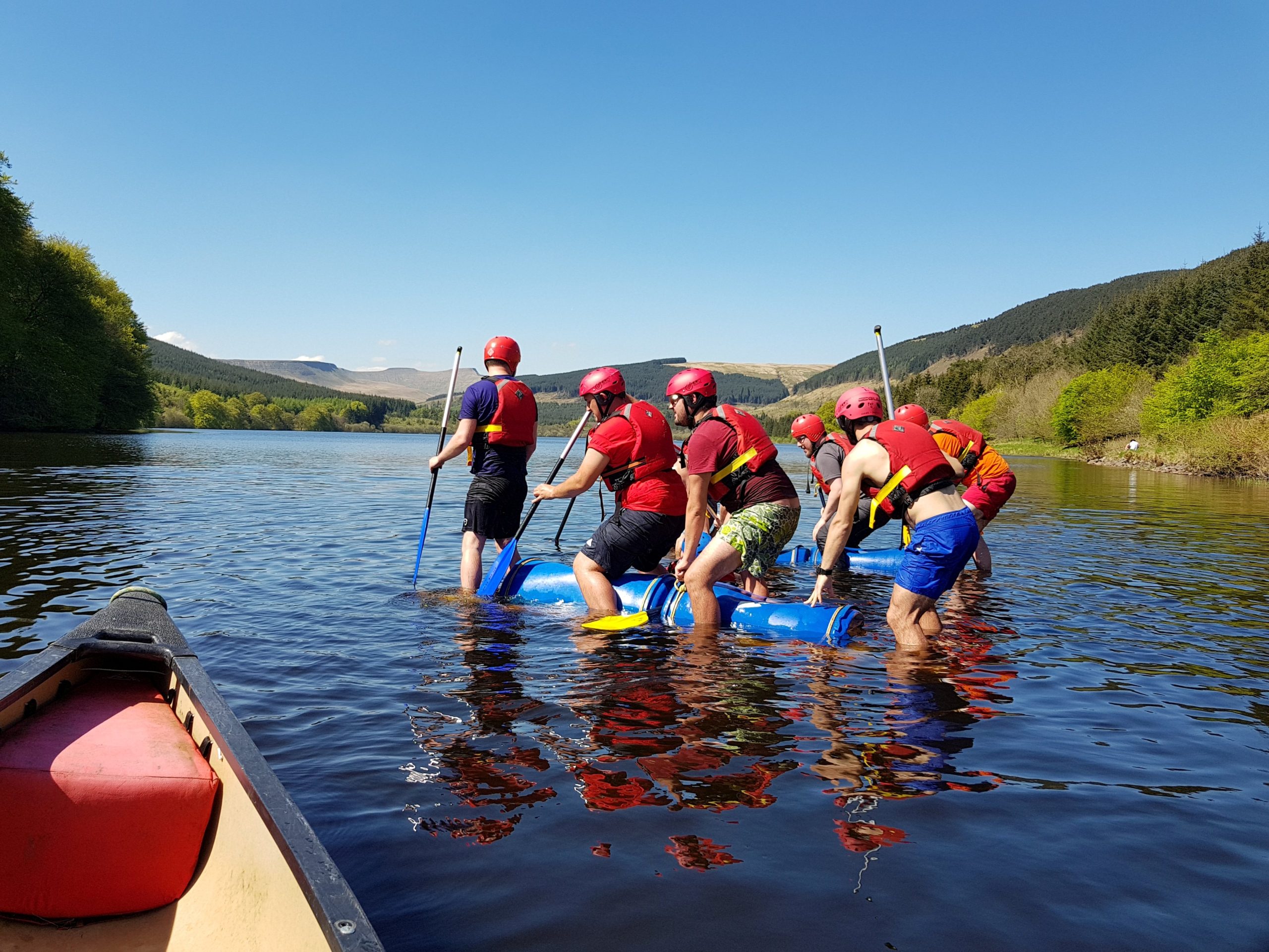 a team building event where they build a raft and the take it out on the water.