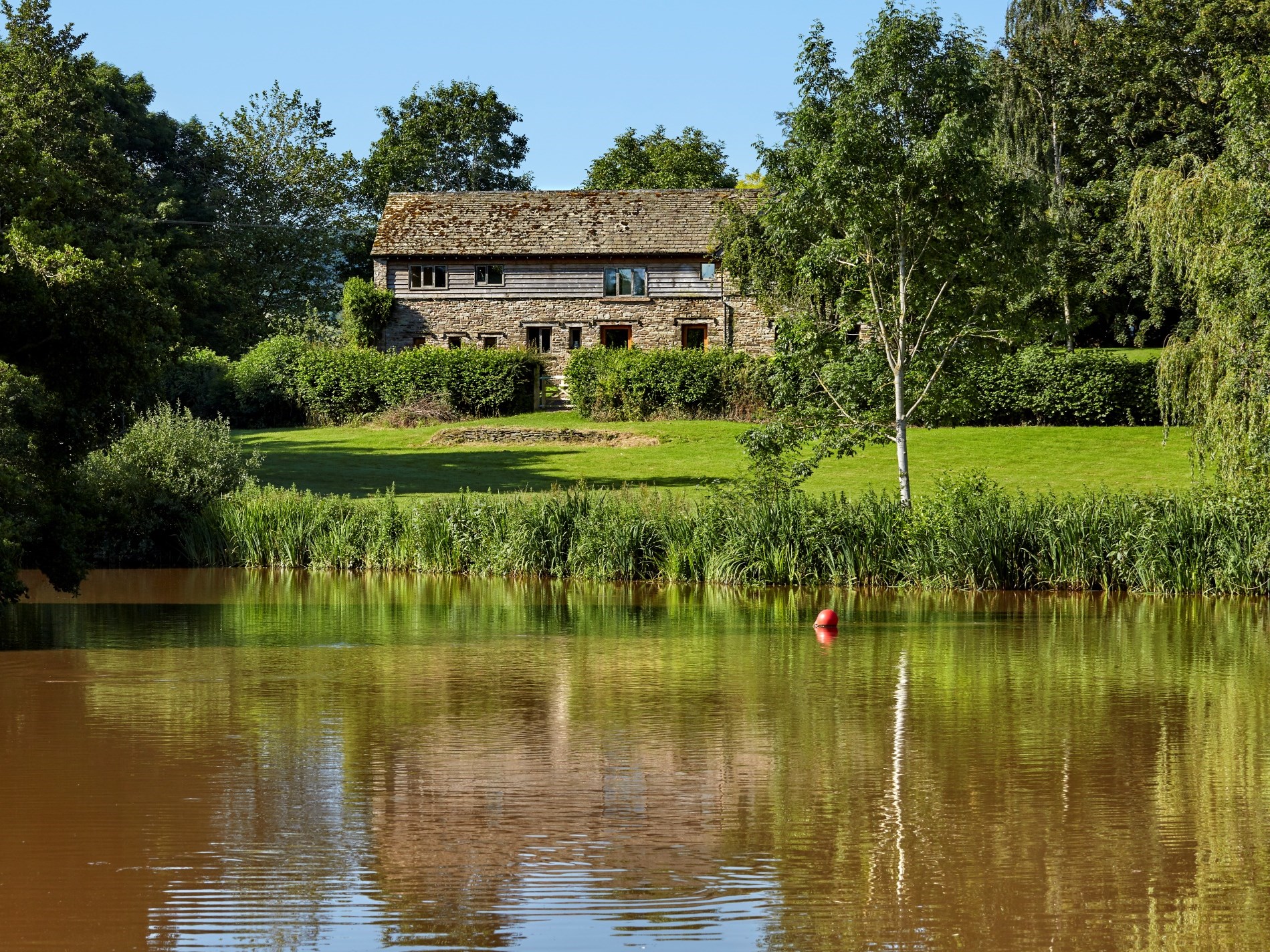 Converted barn overlooking a lake in Bannau Brycheiniog (Brecon Beacons) National Park