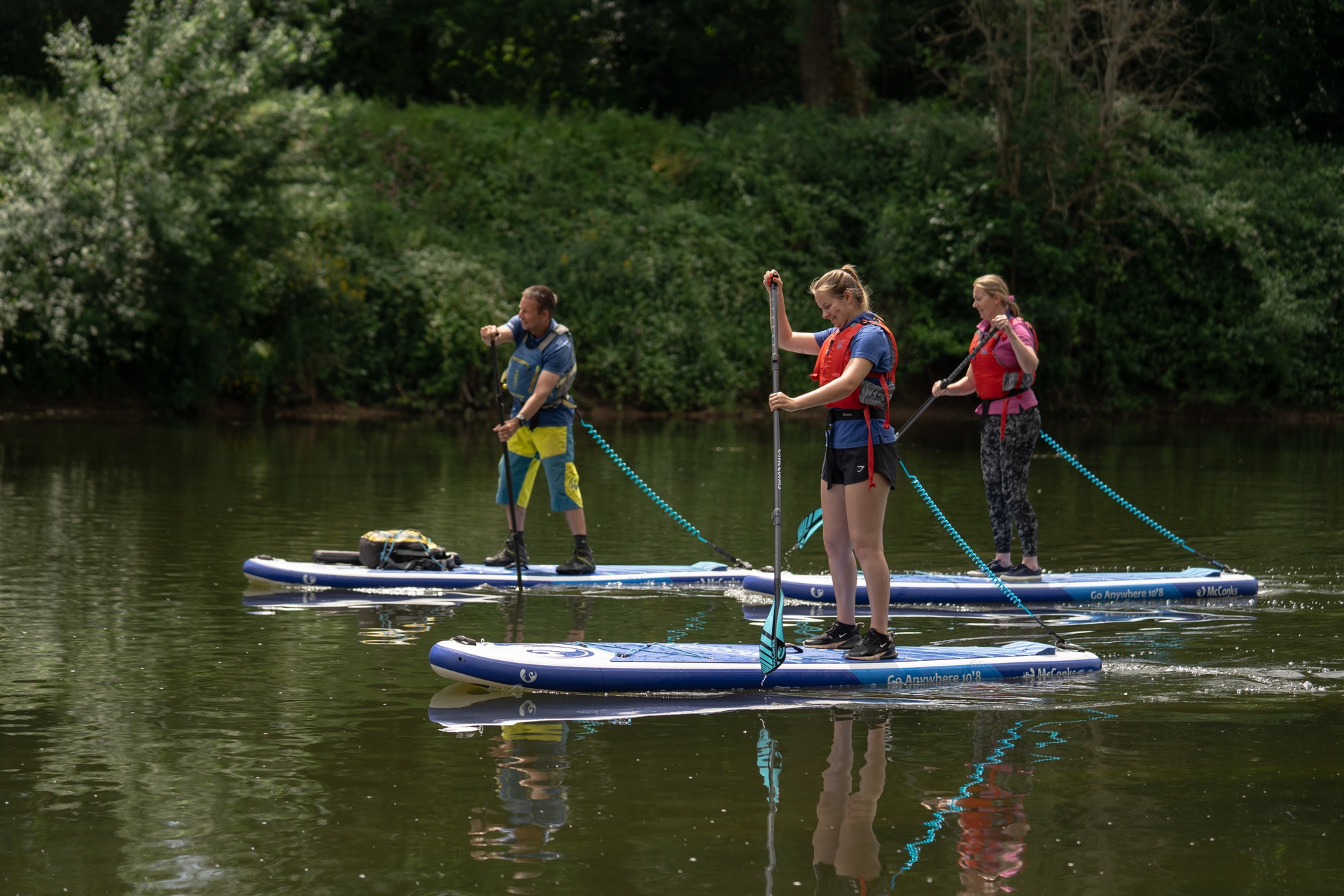 Stand-up paddle boarding on calm water in Bannau Brycheiniog.