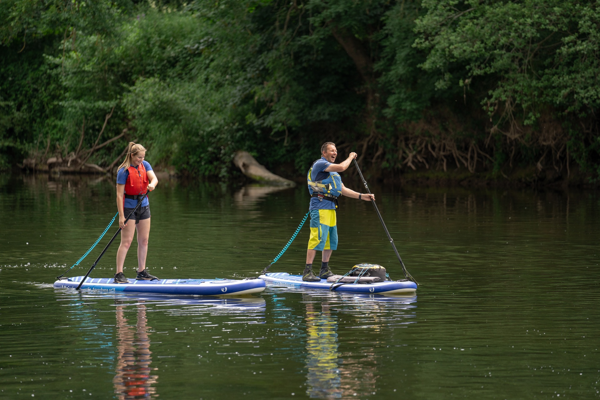 Group learning paddle boarding skills on open water.
