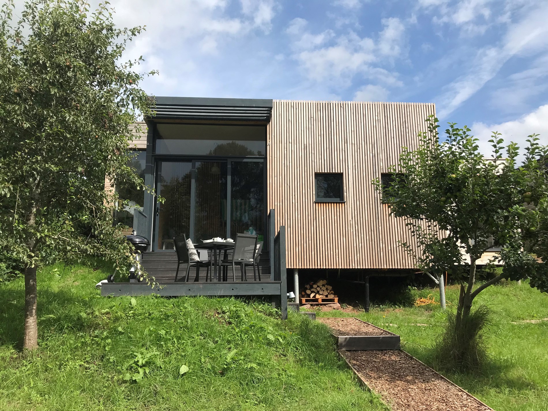 Modern eco lodge with outdoor seating and countryside setting in Bannau Brycheiniog (Brecon Beacons) National Park