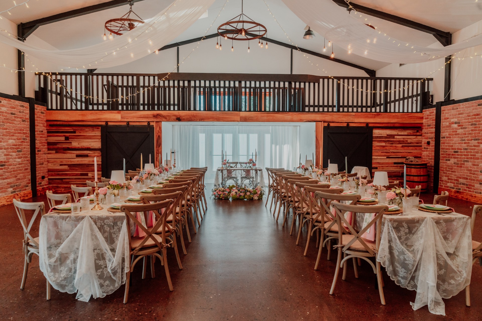 The Grain Store wedding venue at Barn at Brynich, Bannau Brycheiniog (Brecon Beacons) National Park, dressed for a romantic celebration with fairy lights, rustic interiors and beautifully styled reception tables.