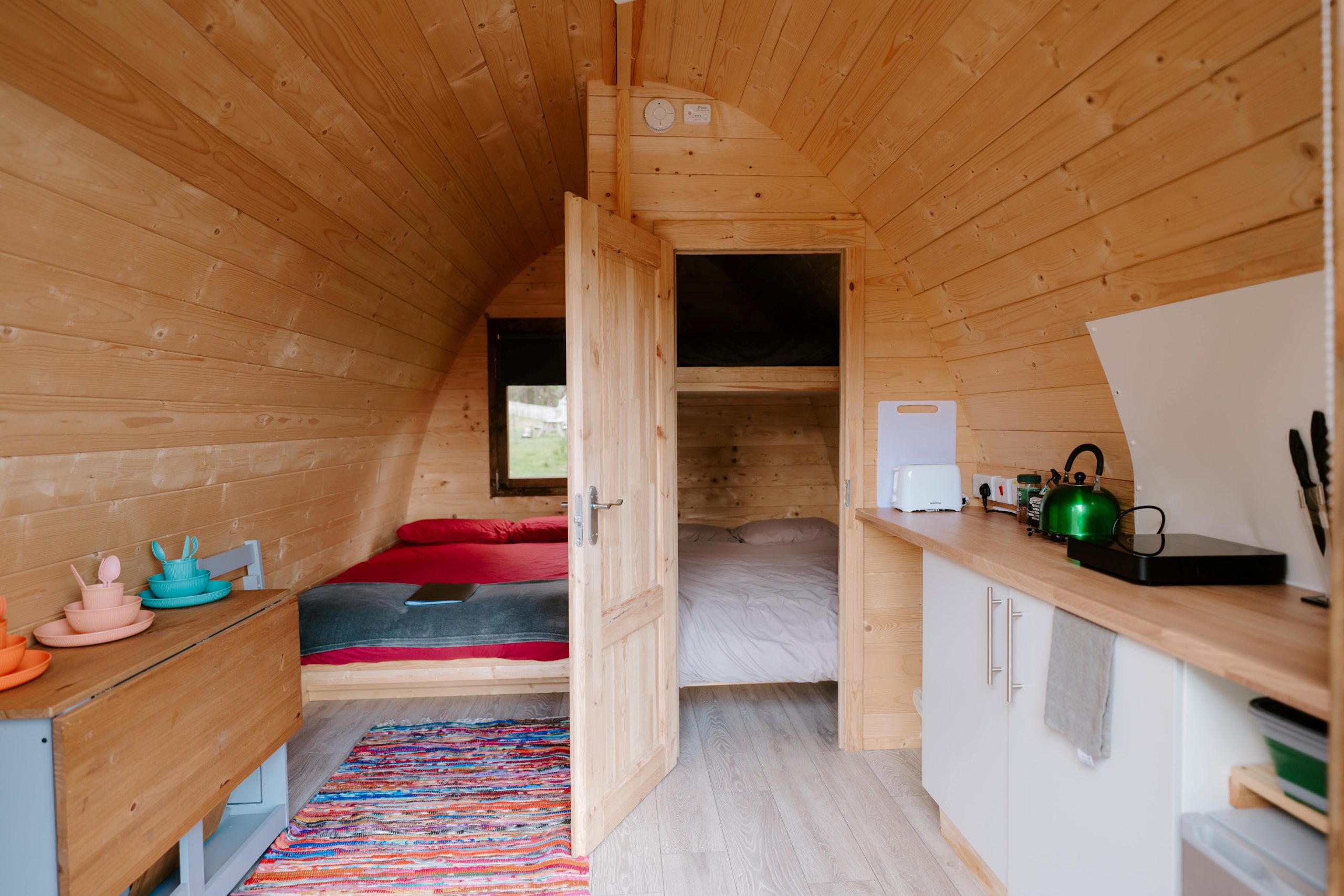 2 double beds in the sleeping area of a pod