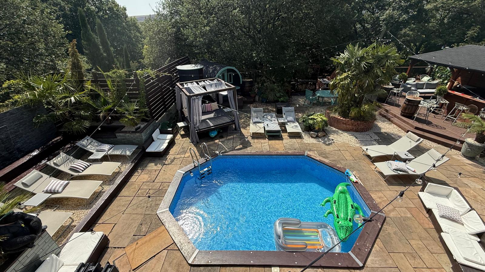 An out door heated poool with reclining beds