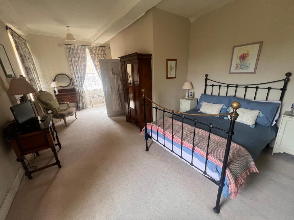 “Light and spacious double bedroom with period features and soft furnishings at Cantre Selyf.”