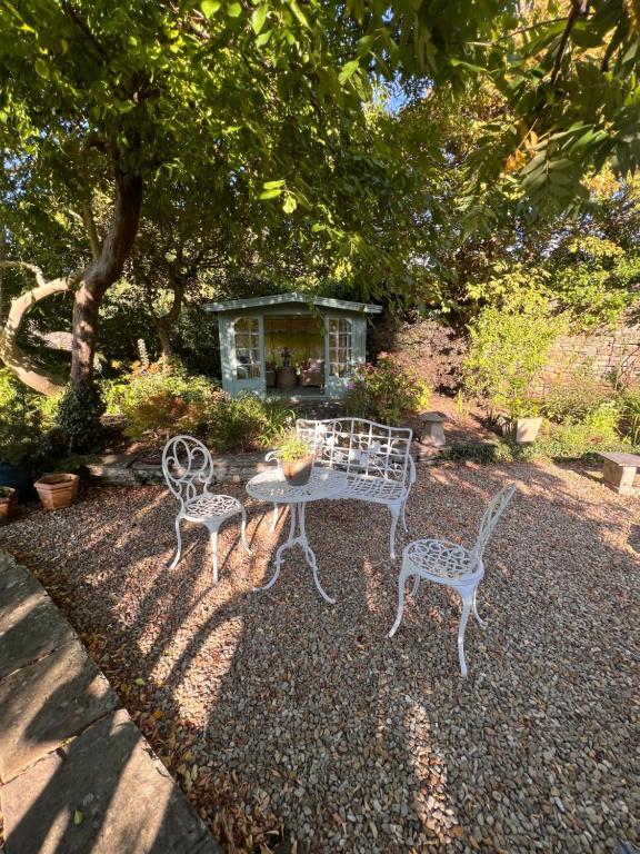 “Enclosed private garden with outdoor seating and mature planting at Cantre Selyf.”