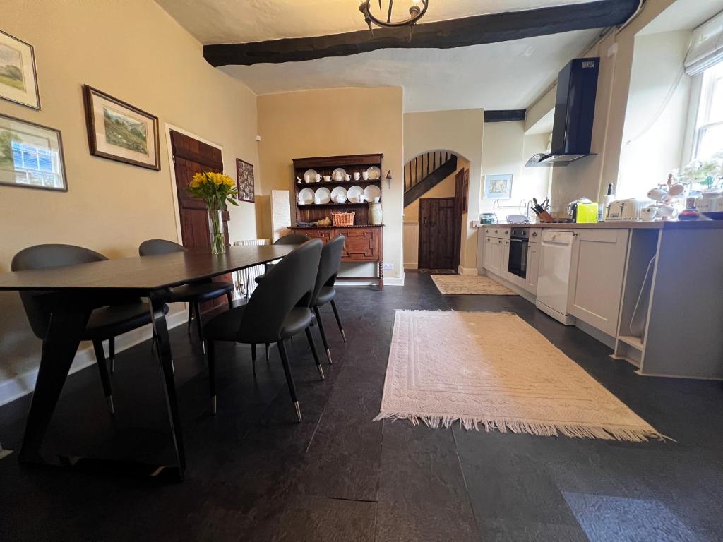 Modern kitchen with dining table and integrated appliances in a Georgian townhouse setting.