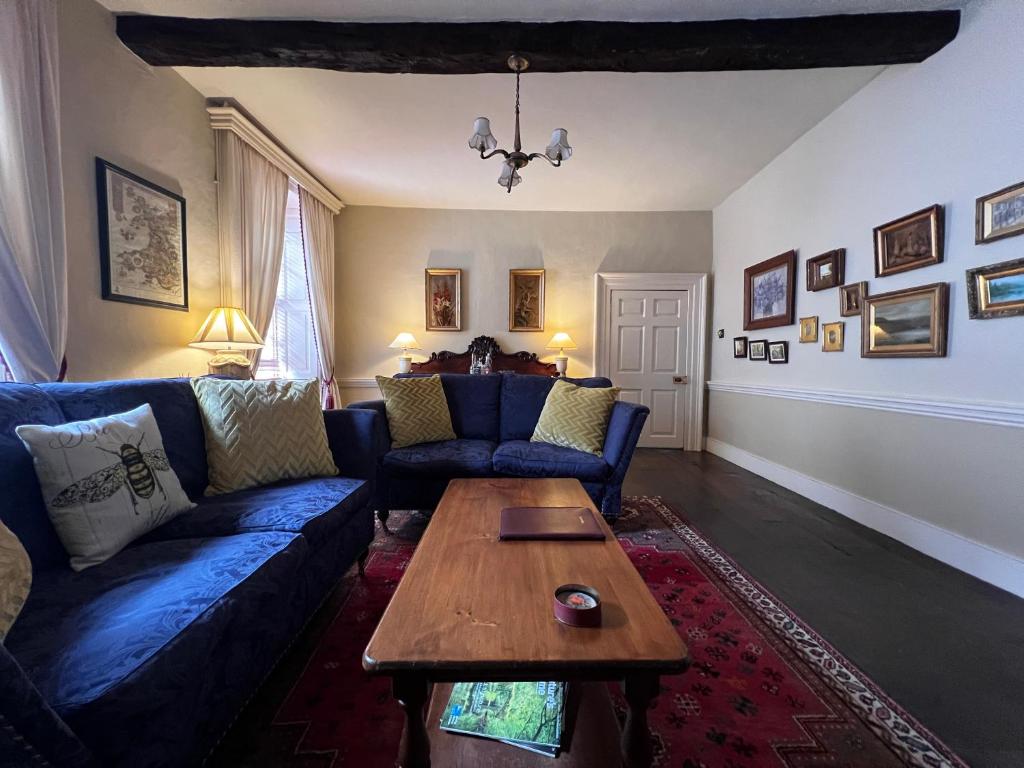 “Stylish lounge with exposed beams and comfortable sofas at Cantre Selyf.