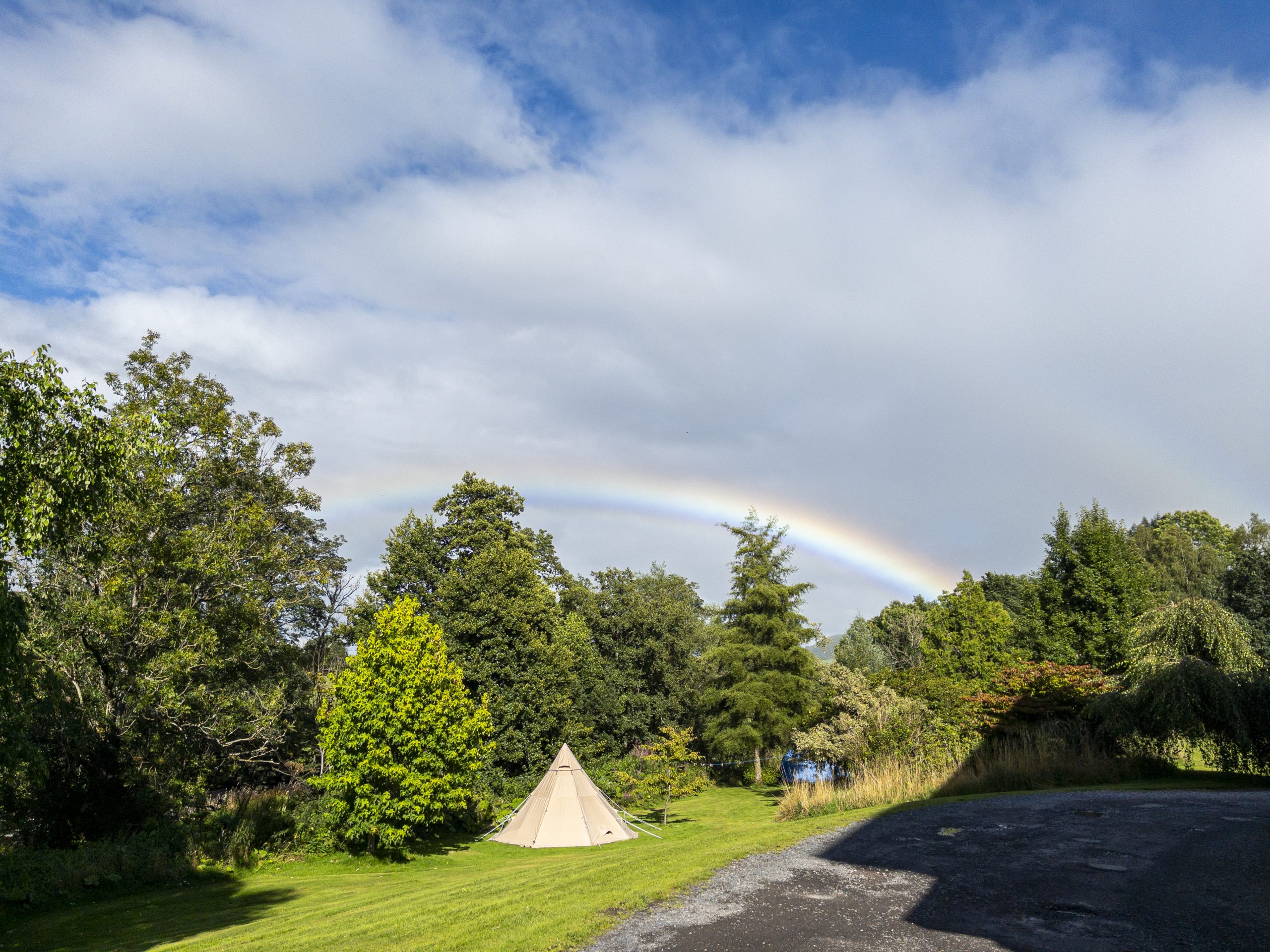 a rainbow over teh canvas tent.