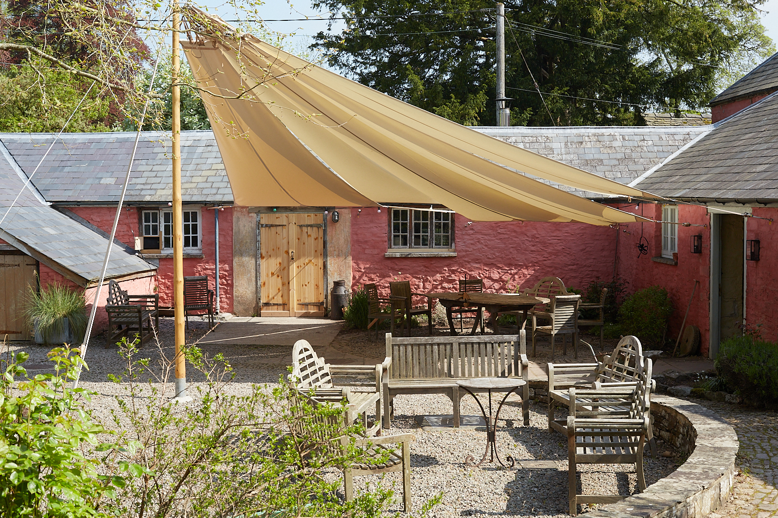 outdoor setaed communal area under a canvas wing for shelter from sun or rain