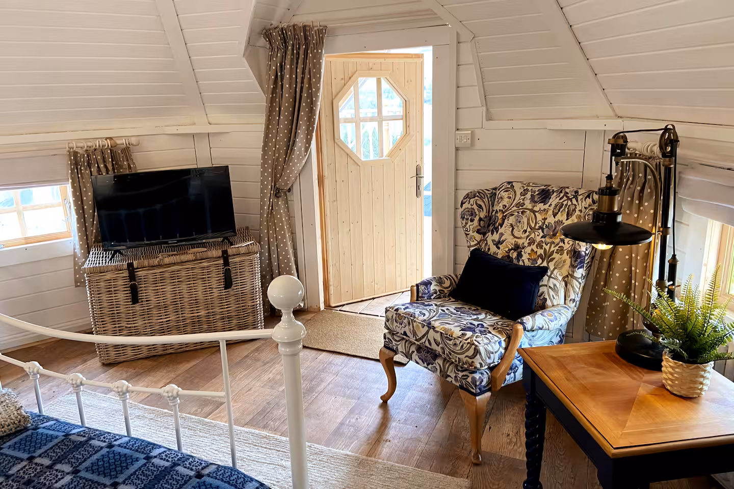 Open-plan living and sleeping space at Flora’s Cabin, part of the Pencerrig Collection