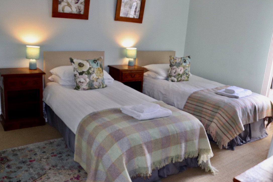 twin bedded room in neutral tones at Glansevin Mansion