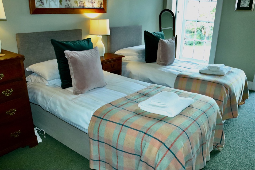 double bedded room in neutral tones at Glansevin Mansion
