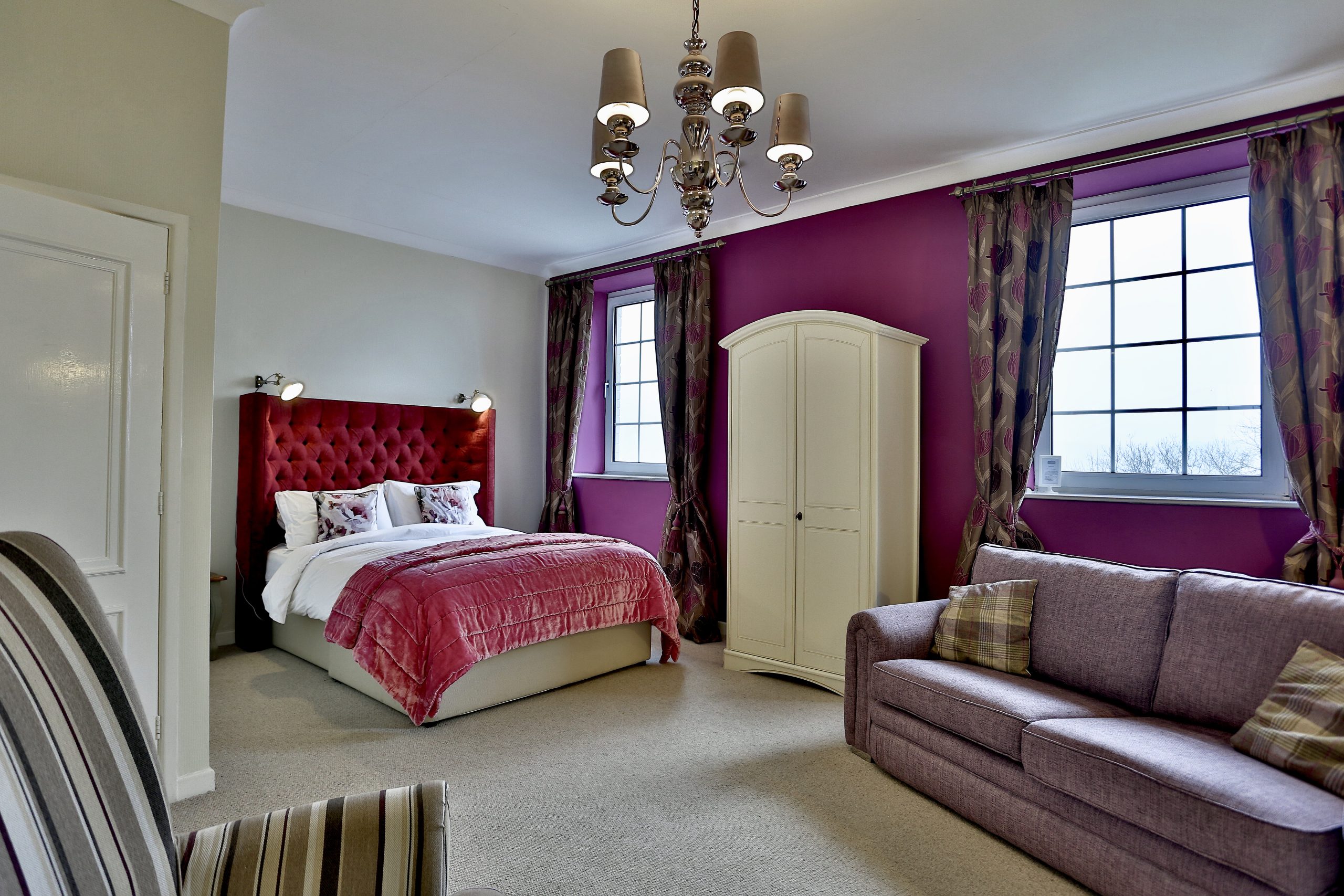 Comfortable guest bedroom at Ty Croeso designed for group stays.