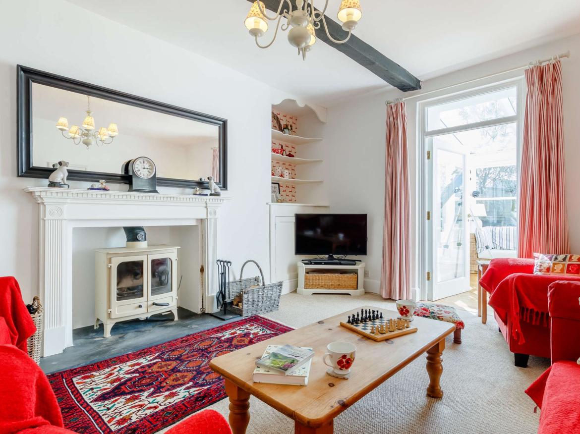Spacious sitting room at Tower House with traditional features and garden access.