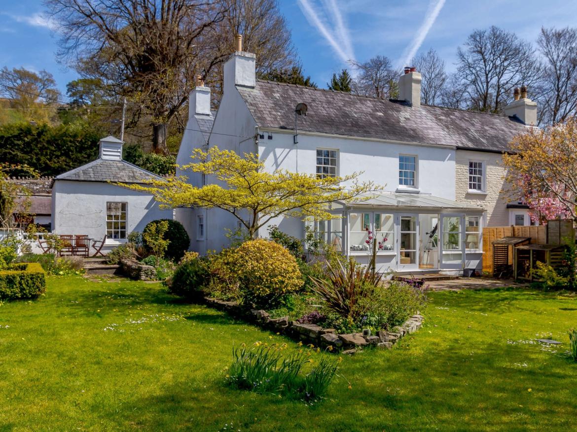 Exterior view of Tower House set within gardens and countryside near Llangorse.