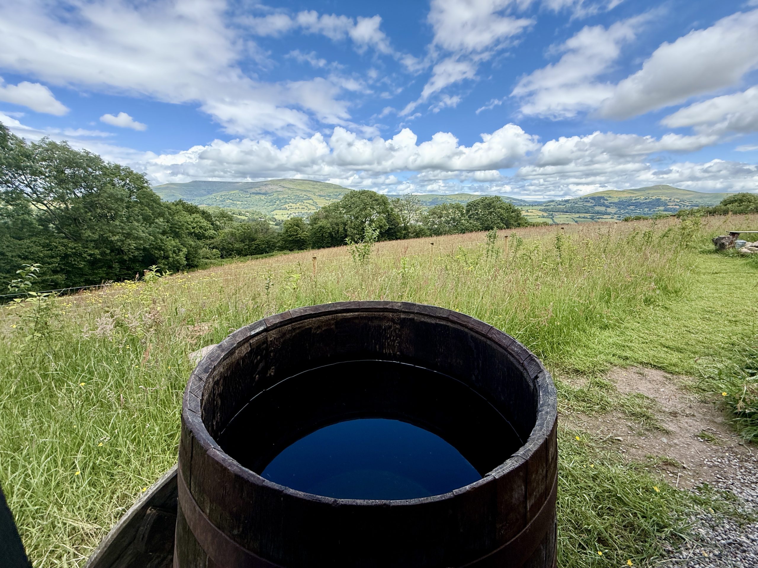 Cold plunge at Caban Tarren surrounded by rolling countryside in Bannau Brycheiniog