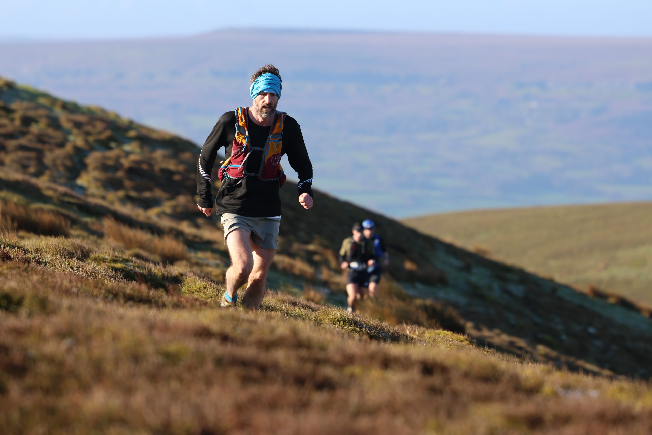 Beast of the Blacks competitors running in the hills