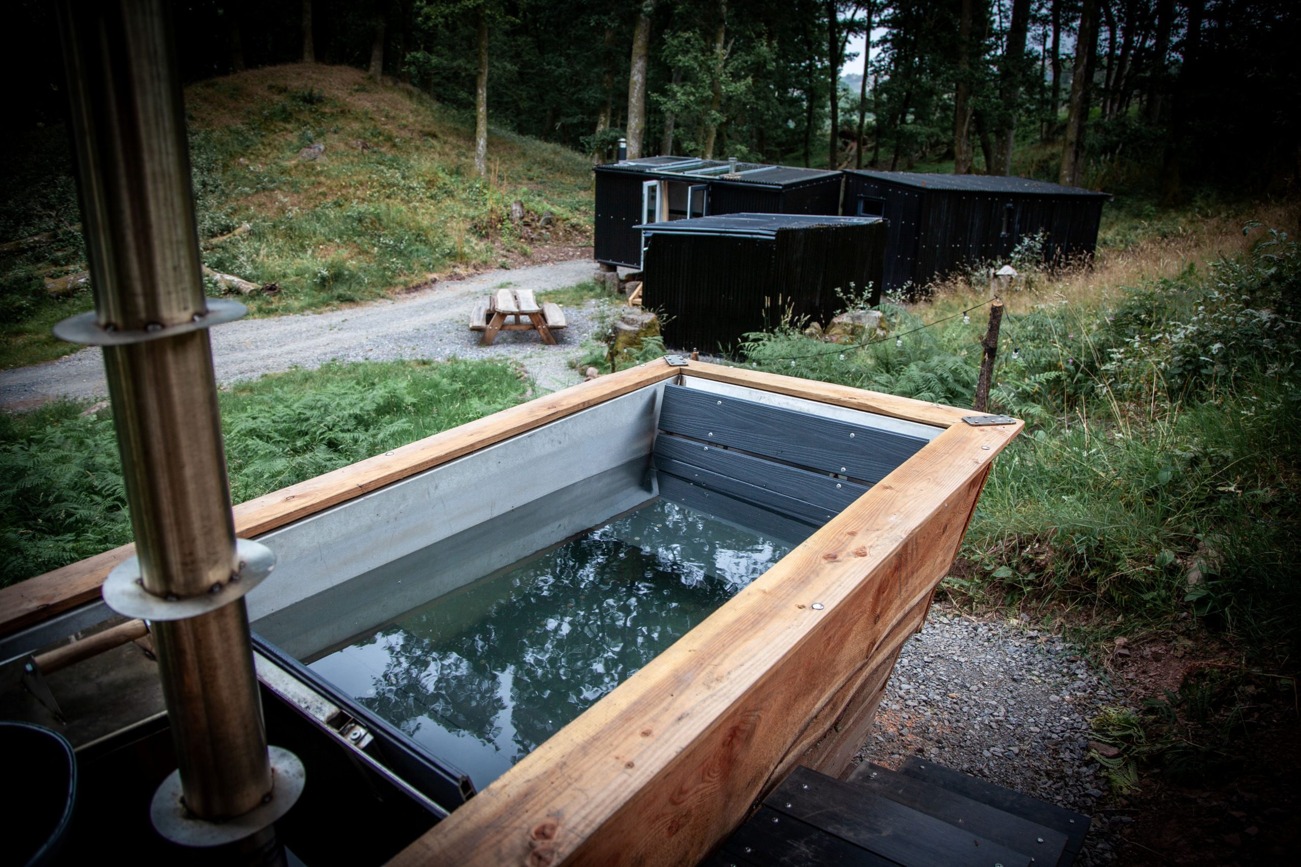 Wood-fired hot tub nestled amongst mature woodland at Henbont Holidays.