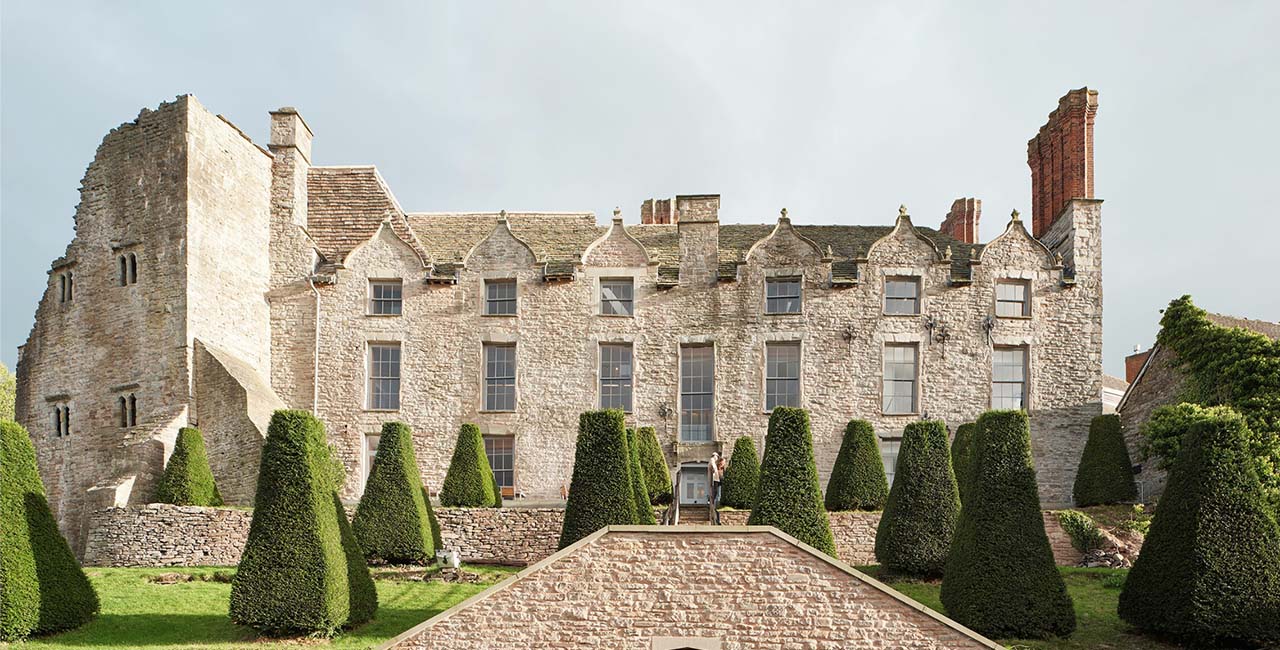 Hay Castle’s stone façade above clipped shrubs and garden steps