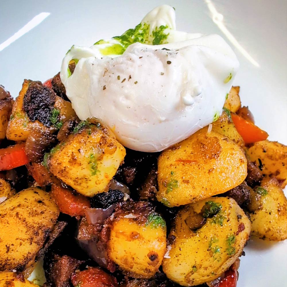 Chorizo and potato hash topped with a poached egg at Book-ish Café.