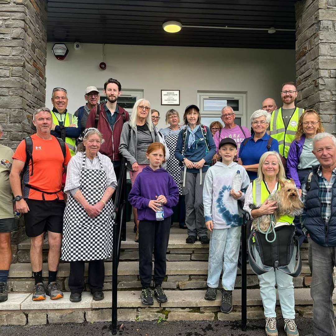 A group gathered on the entrance steps of Penderyn Community Centre