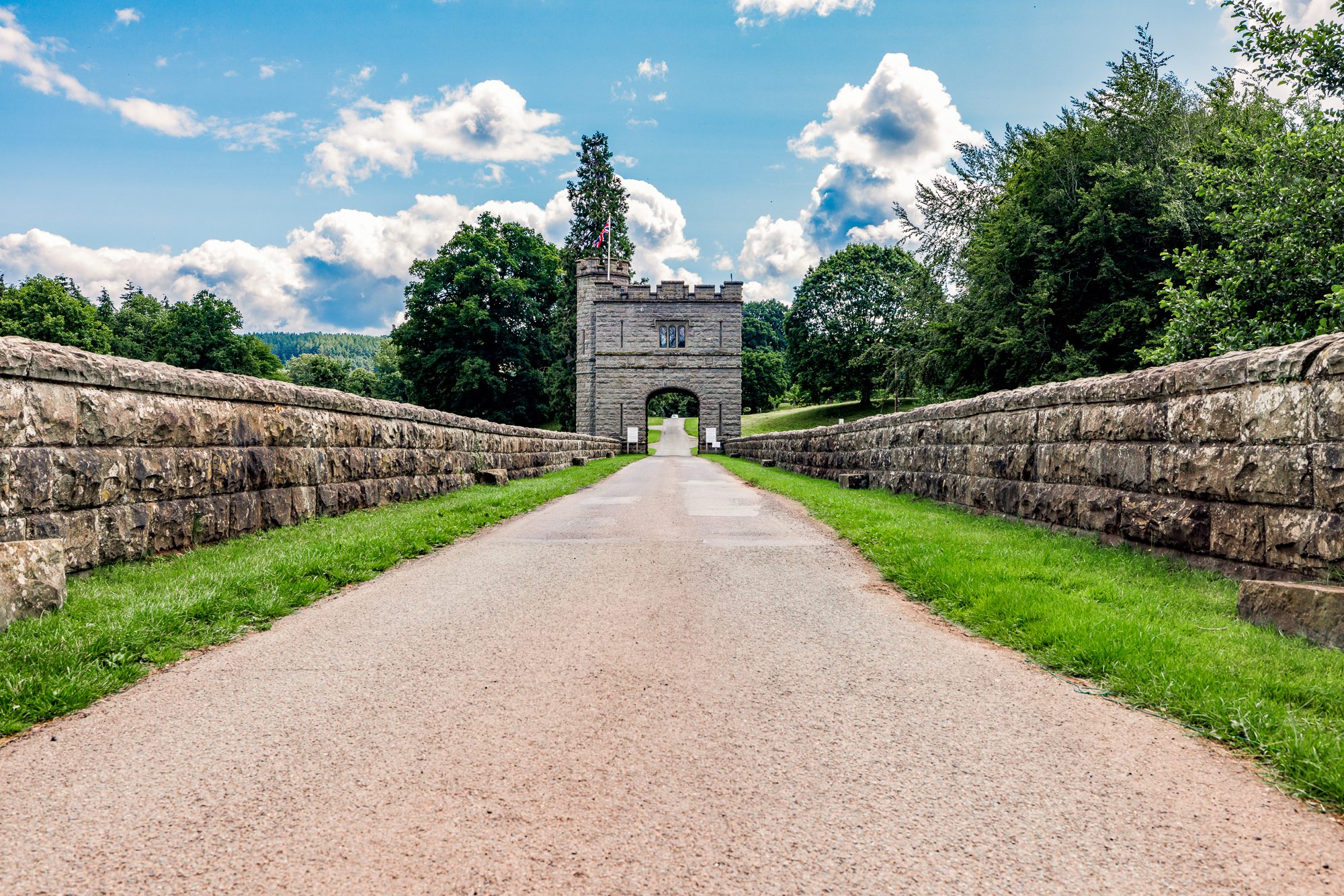 Stone bridge leading to the castellated Tower with an arched entrance at Glanusk Estate