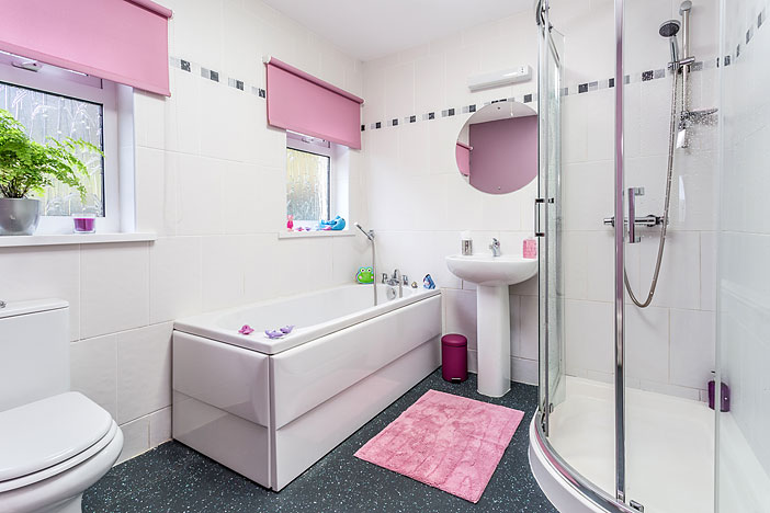 Separate bath and curved shower enclosure in the Farm Cottage bathroom at Tan yr Eglwys.