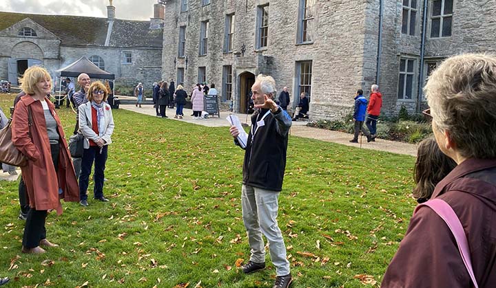 Visitors gathered on the lawn outside Hay Castle during a guided tour