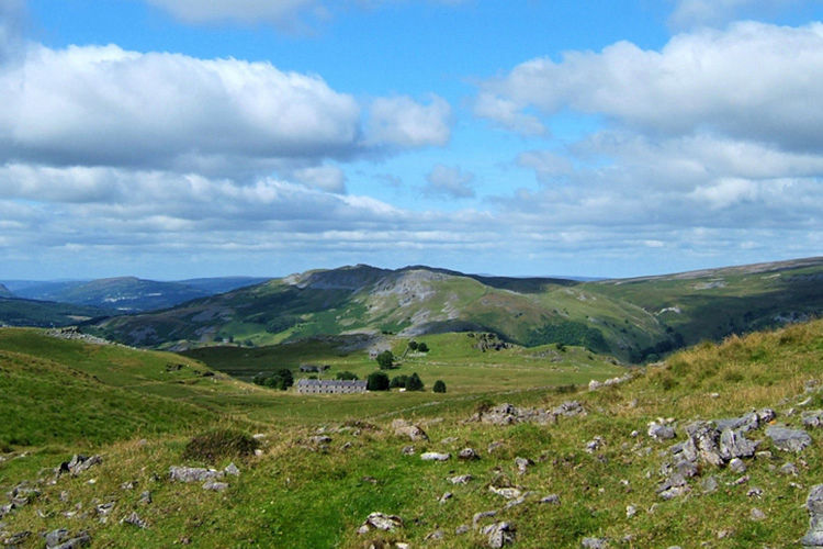Green hills and the wooded valley surrounding Dan-yr-Ogof near Abercraf.